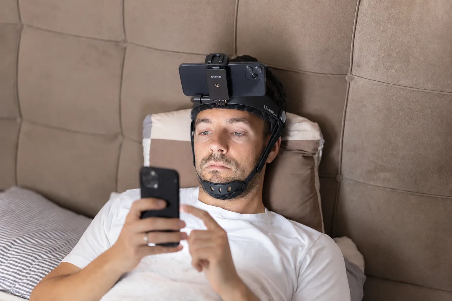 Person lying in bed and scrolling on a phone